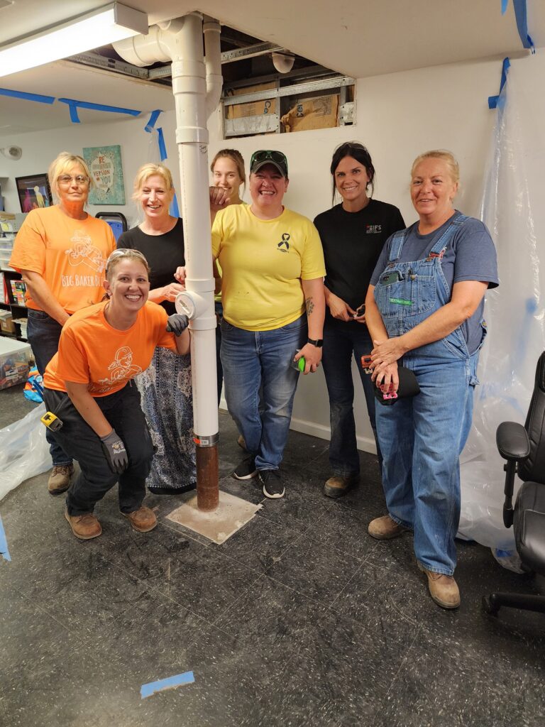 Local 562 tradeswomen provide plumbing expertise at transitional housing